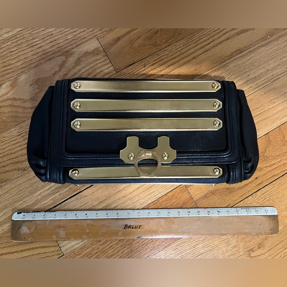 Zac Posen black leather clutch with gold accent bars on both sides